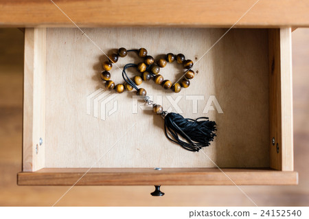 rosary from tiger-eye gems in open drawer 24152540