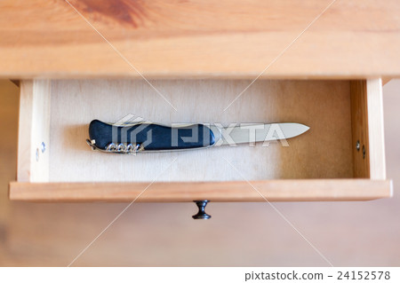 pocket knife in open drawer 24152578