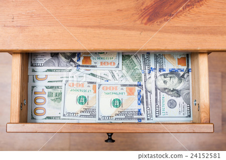 many one hundred dollar bills on bottom of drawer 24152581