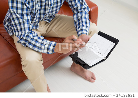 A young man sitting on the sofa 24152651