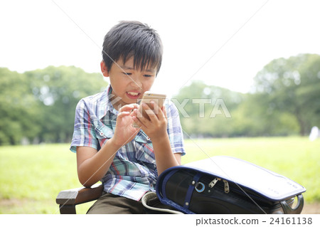 Elementary school student using a smartphone Elementary school student using a smartphone 24161138