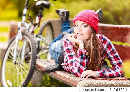 girl relaxing in autumnal park with bicycle. 24161534