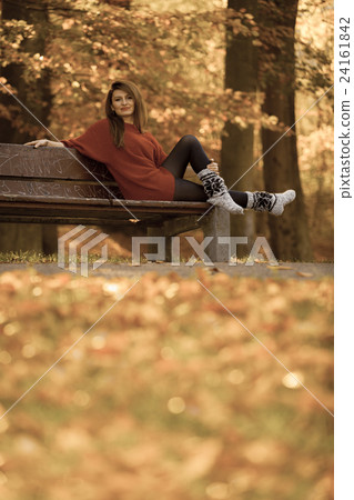 Woman relaxing on bench. 24161842