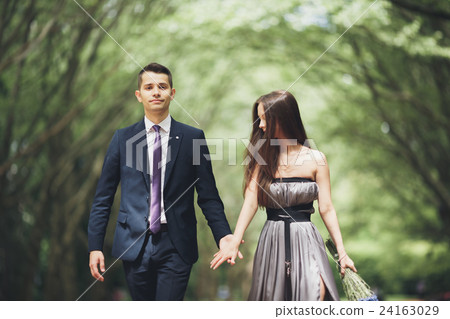 Handsome young couple posing outdoors after Handsome young couple posing outdoors after 24163029