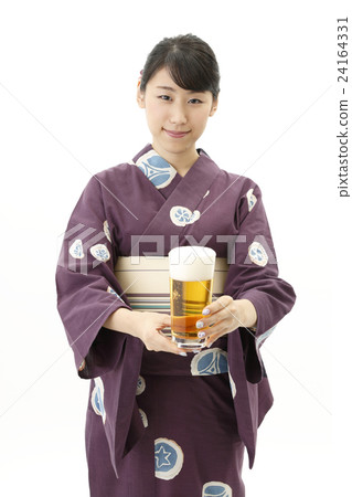 A woman in a yukata with a beer 24164331