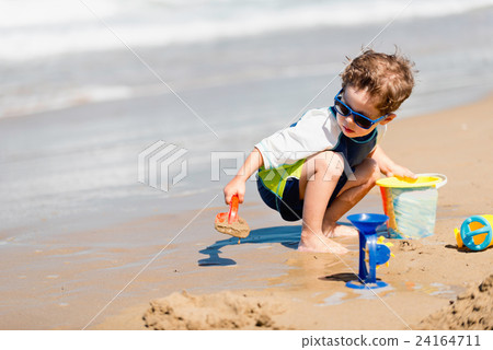 Boy playing on the beach Boy playing on the beach 24164711