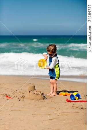 Little boy making sand castle 24164725