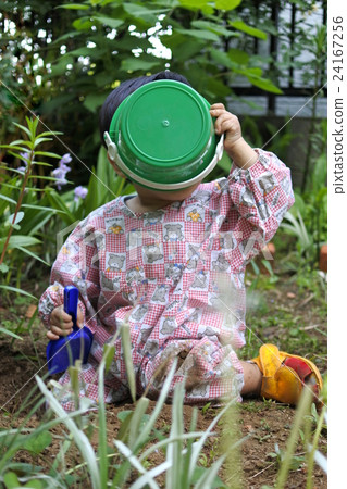 One year old boy playing in the garden One year old boy playing in the garden 24167256