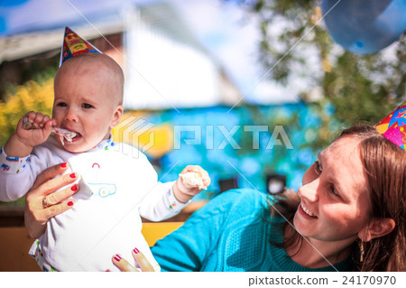 Mom and baby celebrate birthday in sunny day at Mom and baby celebrate birthday in sunny day at 24170970