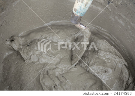 trowel and bucket with mortar at construction site 24174593