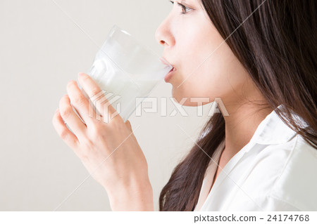 A young lady drinking milk 24174768
