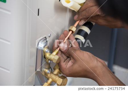 air conditioner, worker connects copper pipe 24175734