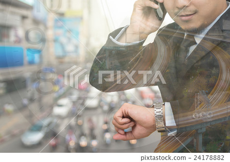 Double exposure of businessman looking his watch and calling phone call in rush hour with traffic jam background,business transportation concept 24178882