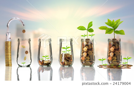 Faucet putting Gold coins and seed in clear bottle on cityscape photo blurred cityscape background,Business investment growth concept Faucet putting Gold coins and seed in clear bottle on cityscape photo blurred cityscape background,Business investment growth concept 24179004