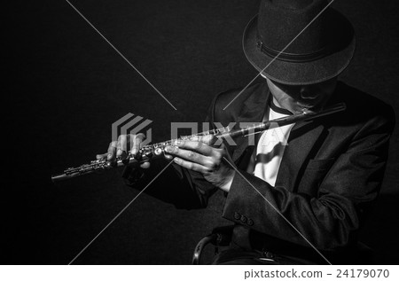 Flute music playing flutist musician performer on black background, musical instrument Flute music playing flutist musician performer on black background, musical instrument 24179070