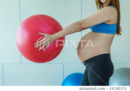 Closeup asian Pregnant female do exercise in sports room, holding the big ball, healthy motherhood concept 24180151