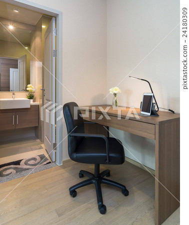 Luxury Workplace with laptop and lamp on wooden table in front of restroom 24180309