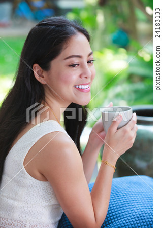 asian woman enjoys fresh coffee in the morning.  24183133