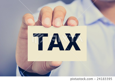 Tax word on business card shown by a man Tax word on business card shown by a man 24183395