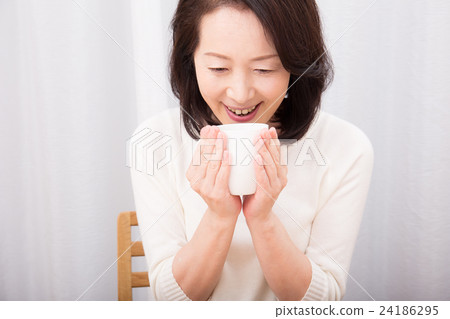 A woman drinking a drink 24186295