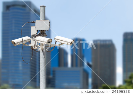 CCTV pillar with building in the city background CCTV pillar with building in the city background 24196528