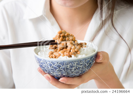 A woman eating natto 24196664