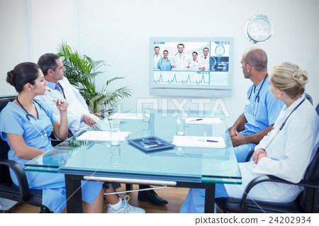 Composite image of team of doctors having a meeting 24202934