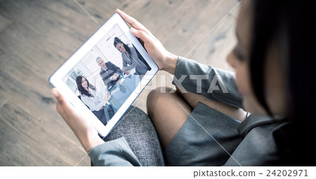 Composite image of businesswoman using tablet Composite image of businesswoman using tablet 24202971