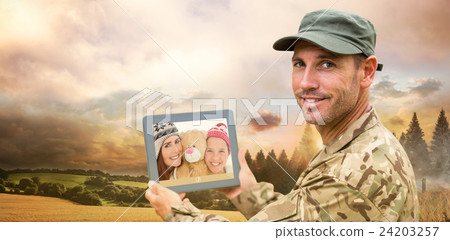Composite image of soldier using tablet pc 24203257