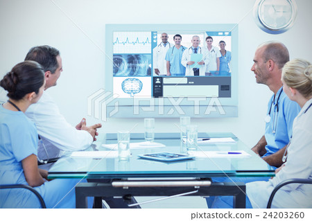 Composite image of team of doctors having a meeting 24203260