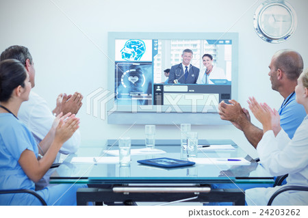 Composite image of team of doctor applauding during meeting Composite image of team of doctor applauding during meeting 24203262