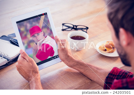 Composite image of rear view of man using tablet on wooden table Composite image of rear view of man using tablet on wooden table 24203501