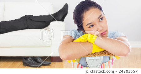 Composite image of troubled woman leaning on a mop Composite image of troubled woman leaning on a mop 24203557