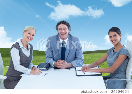 Composite image of portrait of smiling business people sitting at conference table Composite image of portrait of smiling business people sitting at conference table 24204604