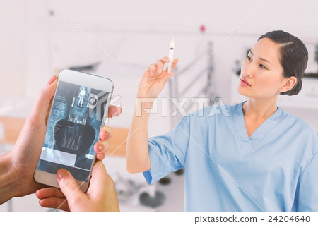 Composite image of serious doctor holding an injection in hospital 24204640