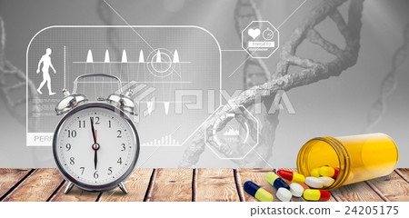 Alarm clock and pills put on a desk 24205175