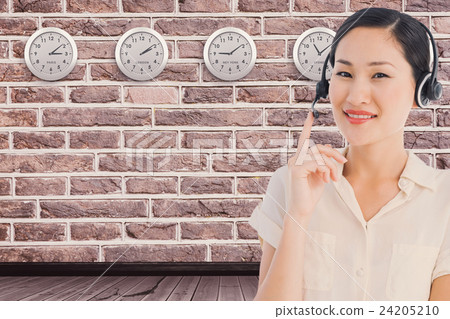 Composite image of beautiful smiling female executive with headset 24205210