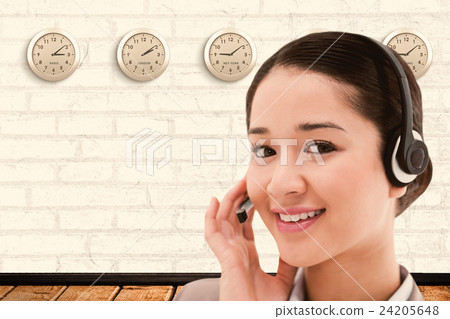 Composite image of close up of a smiling operator posing with a headset Composite image of close up of a smiling operator posing with a headset 24205648