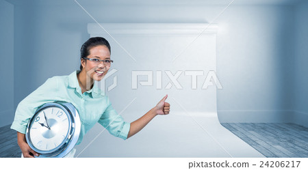 Composite image of delighted businesswoman holding a clock 24206217