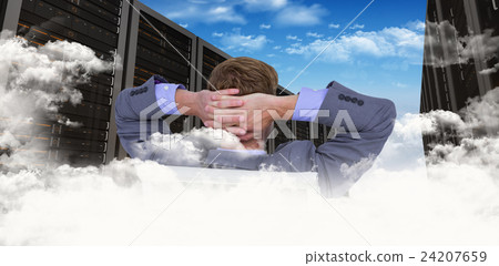 Composite image of relaxed businessman extended on a chair Composite image of relaxed businessman extended on a chair 24207659