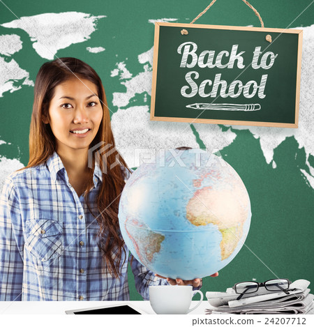 Composite image of smiling asian woman holding a globe 24207712