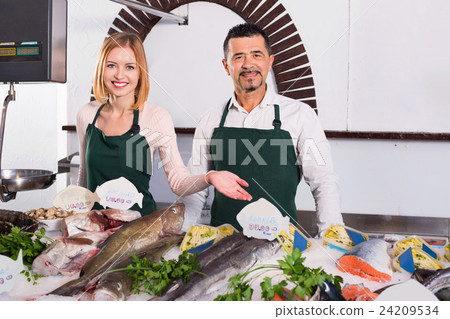 Positive shop assistants selling fresh fish Positive shop assistants selling fresh fish 24209534