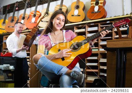 Couple playing the guitars Couple playing the guitars 24209831