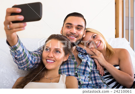 Friends making selfie at home. 24210061