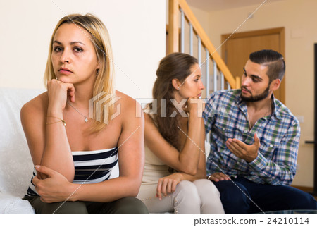 person keeping silence turned away from friends person keeping silence turned away from friends 24210114