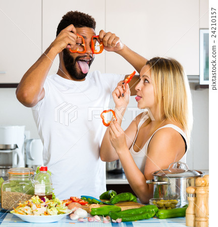 Husband helping wife preparing healthy dinner 24210157
