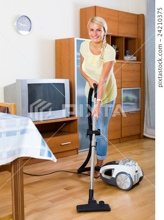 woman using vacuum cleaner 24210375