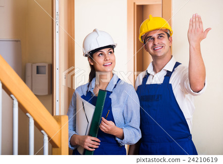 Professional maintenance crew of two specialists indoors 24210619