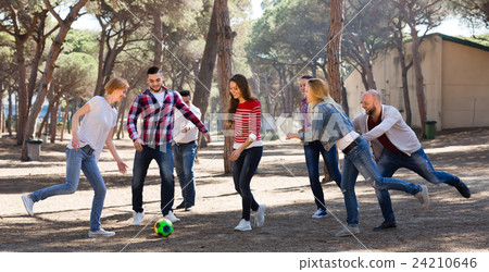 Friends playing football. 24210646