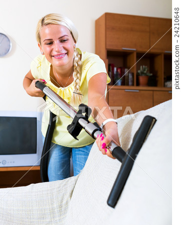 girl hoovering in living room 24210648